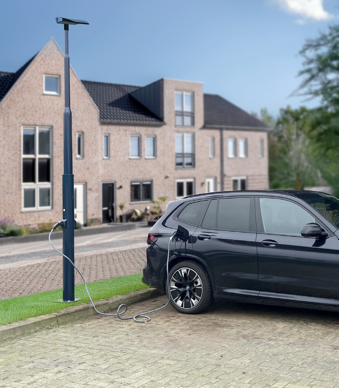 An electric car charging at an e-charging pole