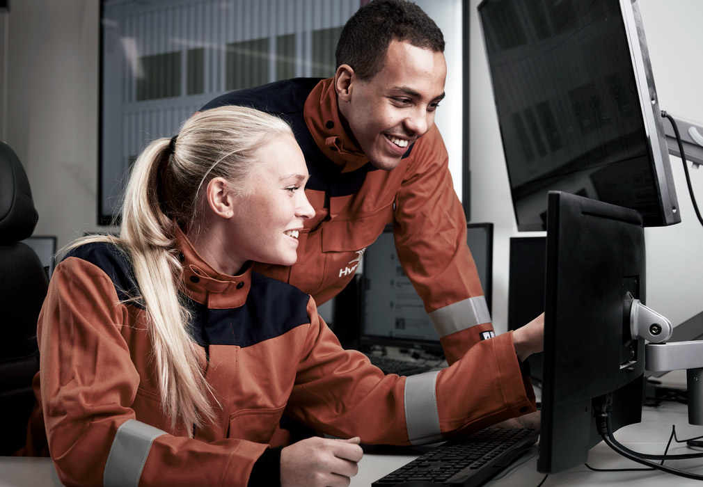 a man and a woman looking at a computer screen