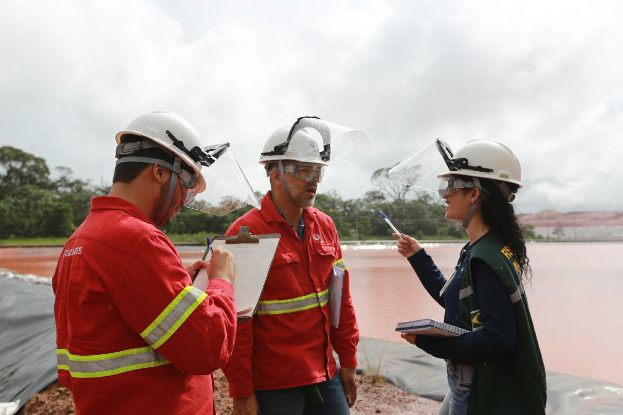 two men and a woman at residue deposit