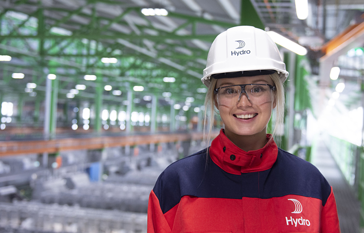 female worker in protective gear on factor floor