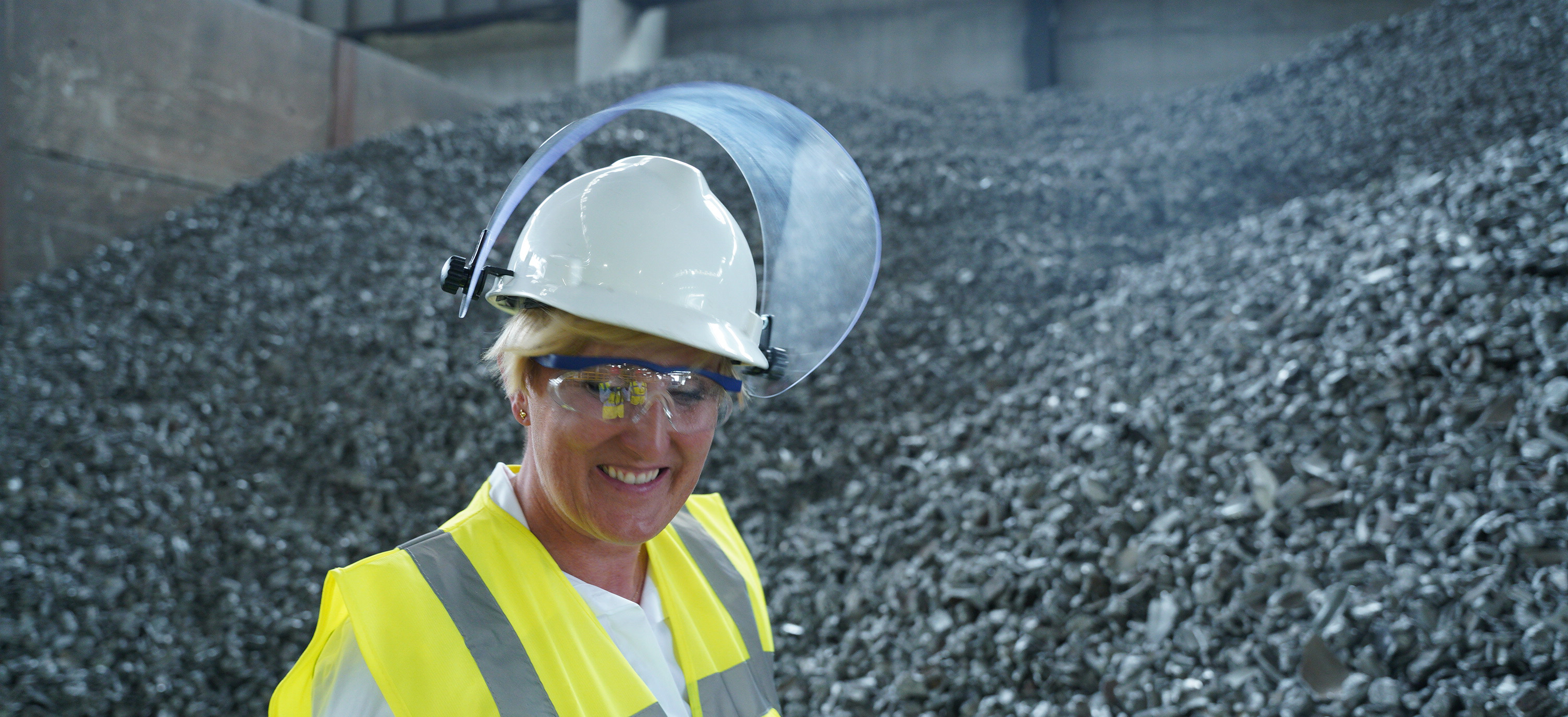 a woman wearing a hard hat and safety goggles