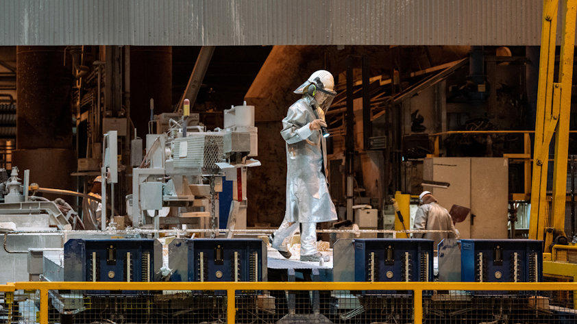 a person in a silver suit working on a machine