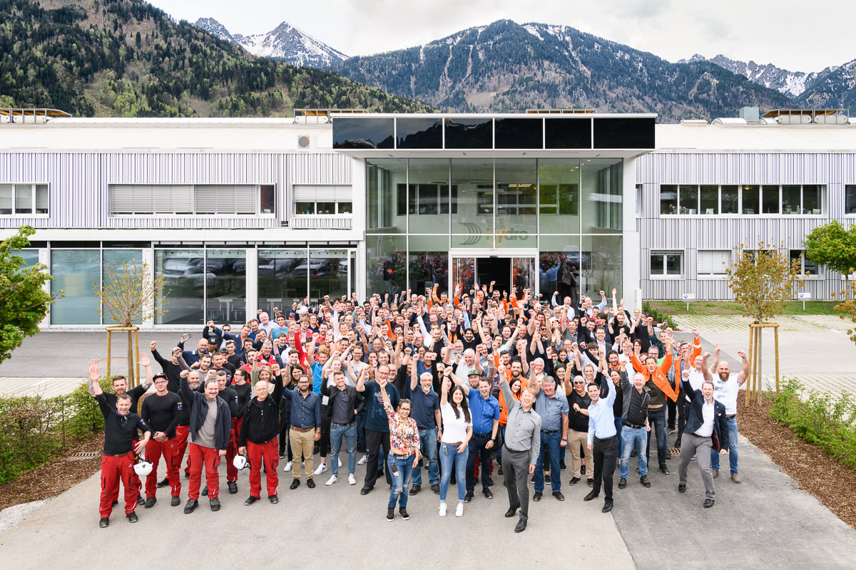 a group of people posing for a photo outside of a building