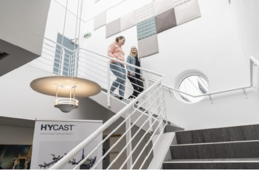 a man and woman standing on the stairs of a building