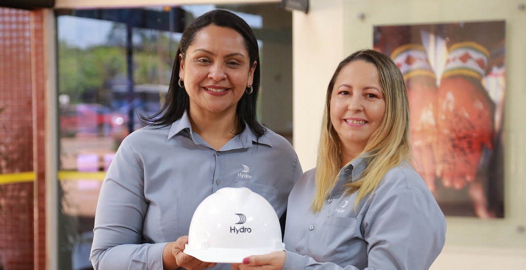 a couple of women holding a white ball